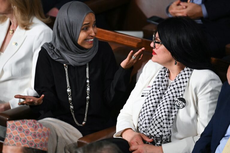 US Representatives Ilhan Omar, Democrat from Minnesota, and Rashida Tlaib, Democrat from Michigan, look on as President Donald Trump delivers the State of the Union address in the House Chamber of the US Capitol in Washington, DC, on February 24, 2026. (Photo by Mandel Ngan/Getty Images)