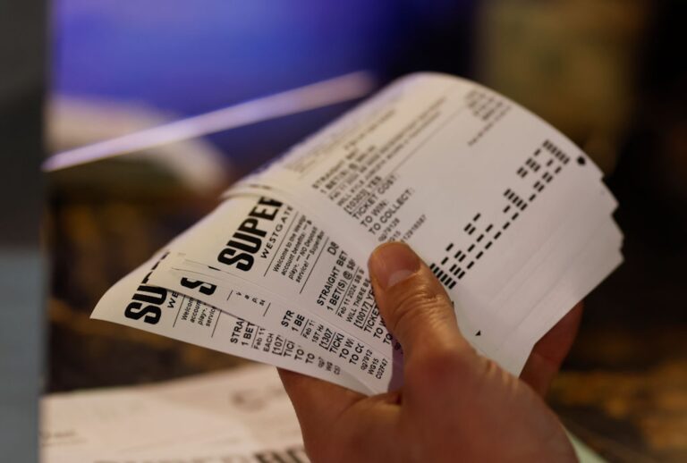 A better looks over their Super Bowl LVIII betting slip tickets (Aaron M. Sprecher/Getty Images)