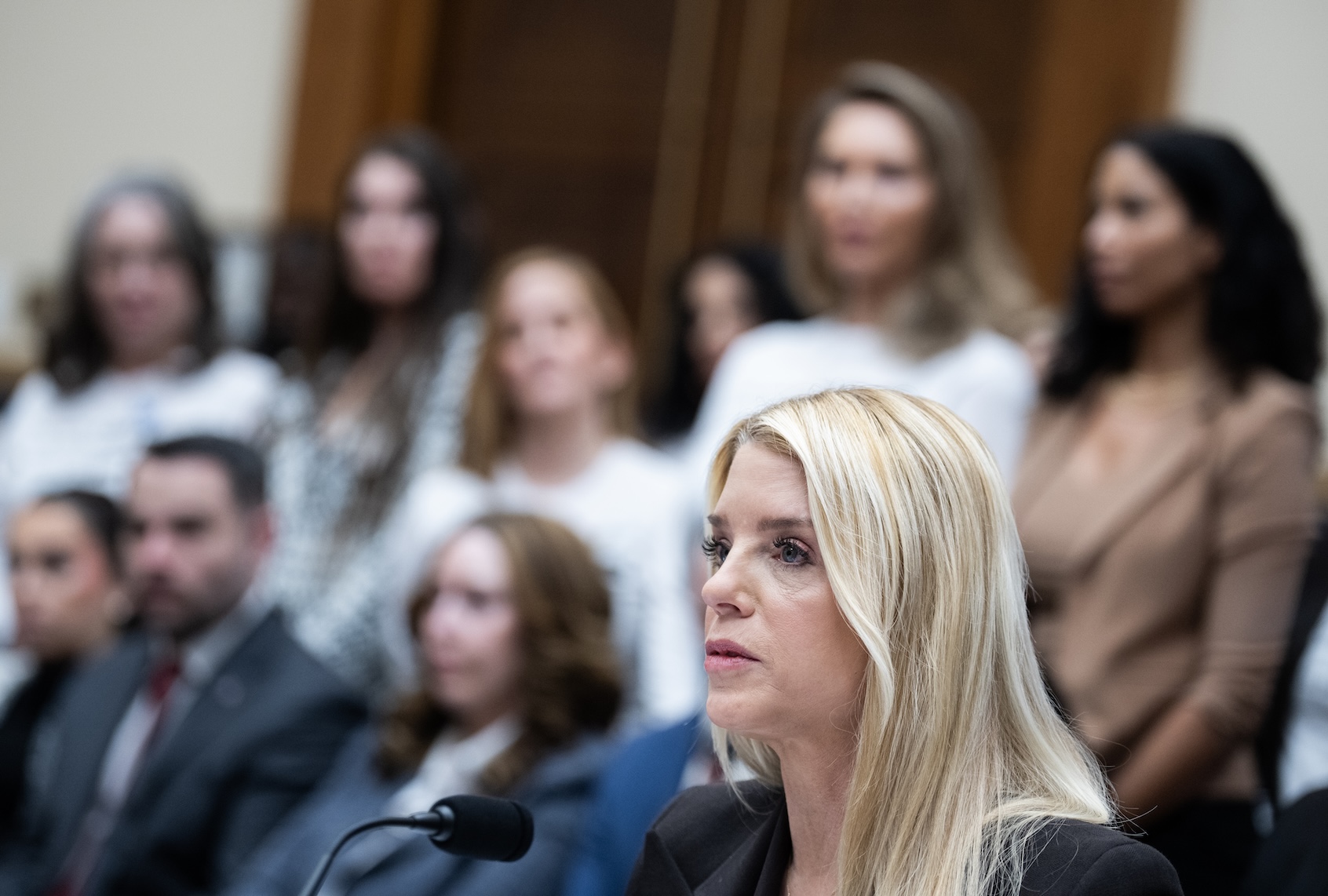 Attorney General Pam Bondi testifies as Jeffrey Epstein survivors stand in the background, during the House Judiciary Committee hearing titled âOversight of the U.S. Department of Justice,â in Rayburn building on Wednesday, February 11, 2026. (Tom Williams/CQ Roll Call via Getty Images)