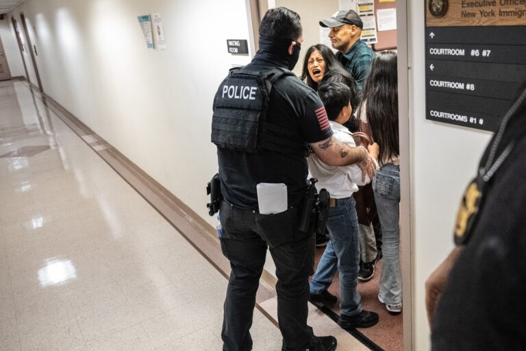 A federal agent restrains the wife of the detained man from Ecuador on September 25, 2025 in New York City. Despite getting continuances on their asylum claims, Federal agents will still detain immigrants who appear for their court dates at the Jacob K. Javits building at 26 Federal Plaza. (Photo by Stephanie Keith/Getty Images)