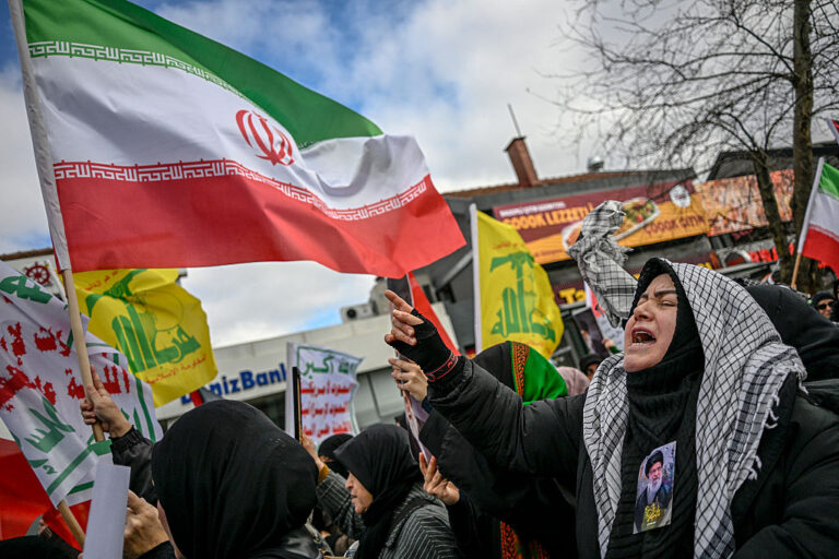 A protestor displaying a portrait of Ayatollah Ali Khamenei on her clothes gestures during a demonstration against the US and Israel attack of Iran and the killing of the Supreme leader. The growing conflict sparks fears of regional war with explosions reported across the Middle East as the Islamic republic retaliated with barrages of missiles. (OZAN KOSE / Getty Images)