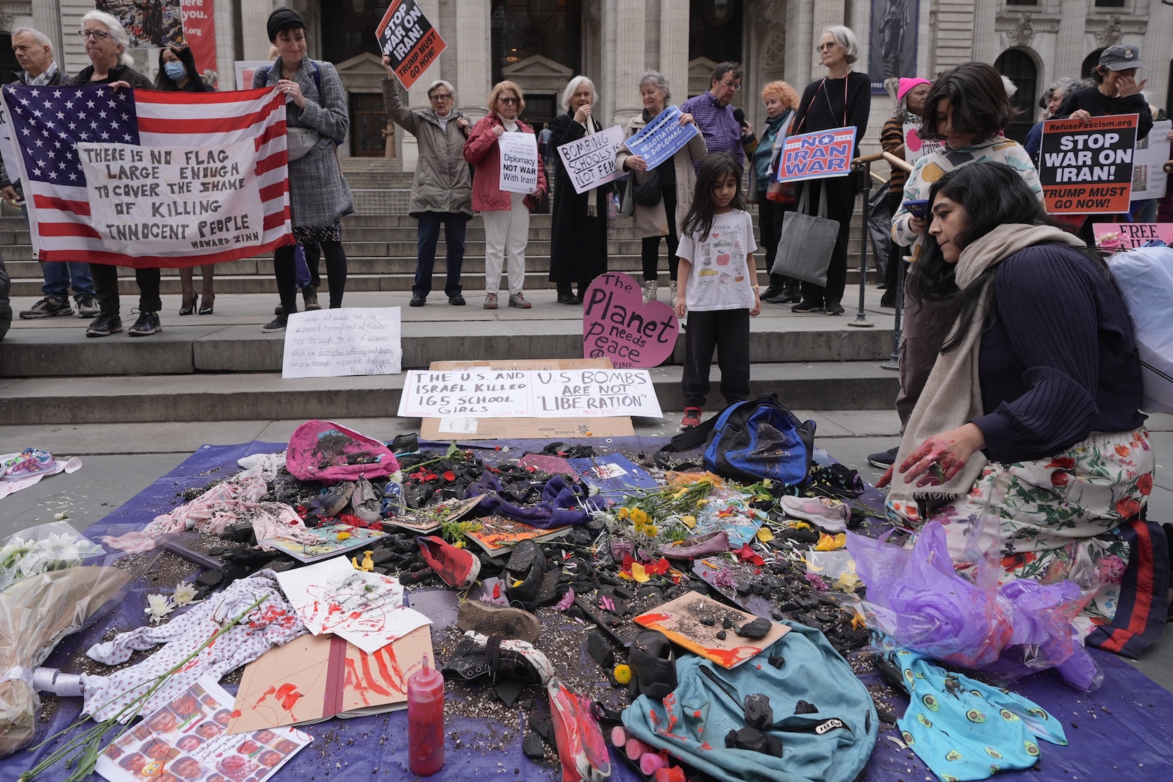 Anti-war protestors gather in front of the New York Public Library and mourn the 180 Iranian children killed during U.S.-Israeli bombing on Shajareh Tayyebeh girls' elementary school in Minab, Iran, on March 08, 2026, in New York City, U.S. (Photo by Selcuk Acar/Getty Images)