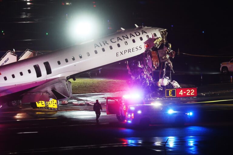 An Air Canada Express plane sits on the tarmac after it collided with a fire truck on the tarmac at LaGuardia Airport on March 23, 2026 in New York City. Two people are believed to have been killed in the late-night accident, with dozens injured. The plane had landed from a flight from Montreal. (Photo by Spencer Platt/Getty Images)