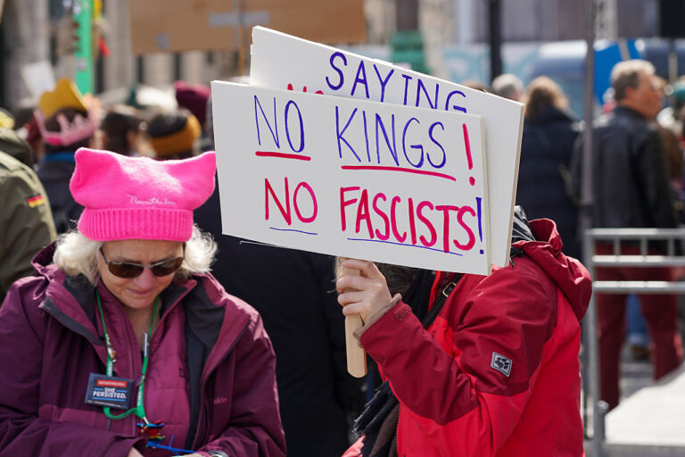A protester in Munich, Germany, holds a ''No Kings, No Fascists'' sign during the ''No Kings, No Fascism'' demonstration. The rally is part of a global movement advocating for democracy and civil rights. (Michael Nguyen / Getty Images)