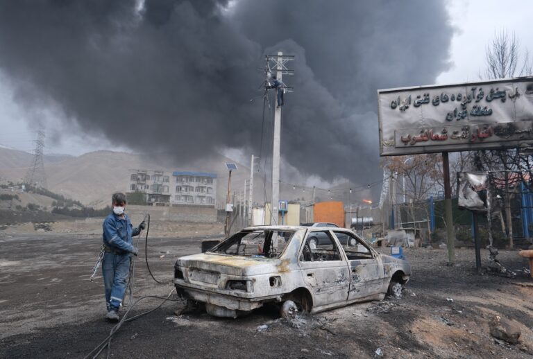 Plumes of smoke rise over the oil depot tanks hit by joint Israel-U.S. over night in a station north west of the capital on March 8, 2026 in Tehran, Iran.