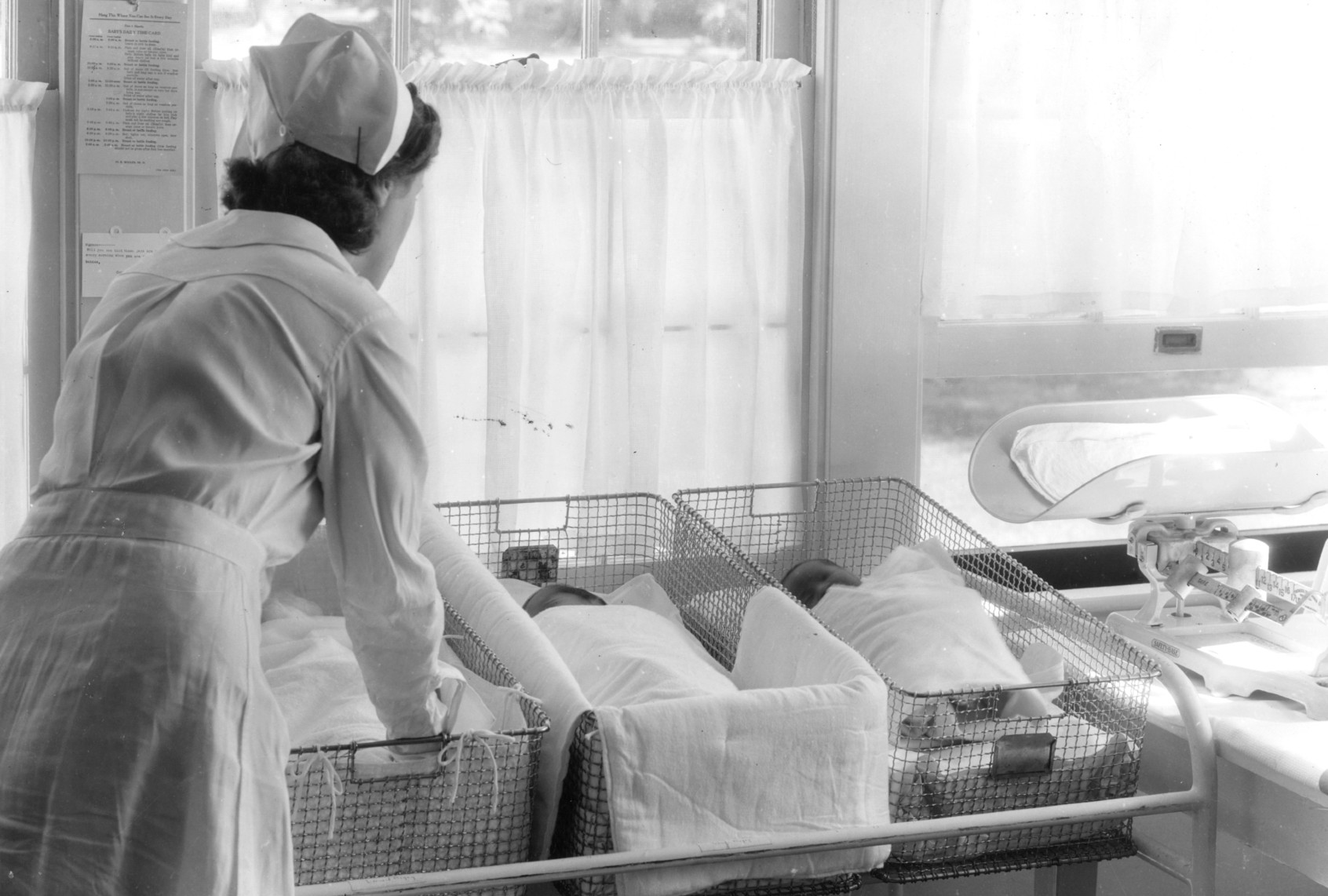 Newborns attended to by a nurse (Visual Studies Workshop/Getty Images)
