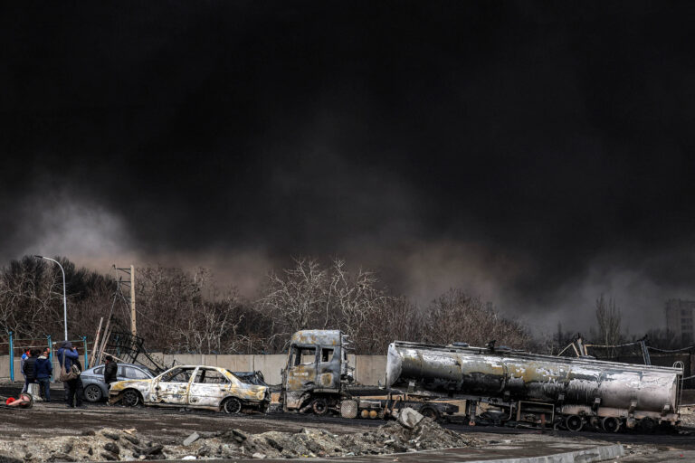 A dark smoke cloud engulfs destroyed vehicles near an ongoing fire following an overnight airstrike on the Shahran oil refinery in northwestern Tehran on March 8, 2026. (Photo by AFP via Getty Images)