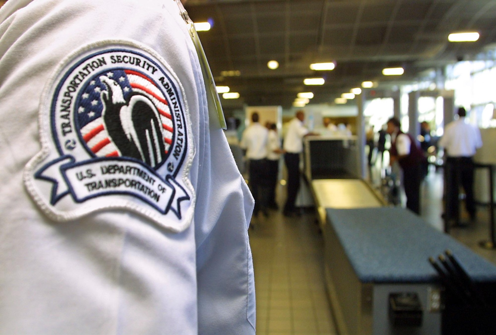 A Transportation Security Administration officer looks over passenger security checkpoint during a tour of the Emergency Preparedness and Domestic Security Program at Los Angeles International Airport 06 March 2003. (Photo by LEE CELANO/AFP via Getty Images)