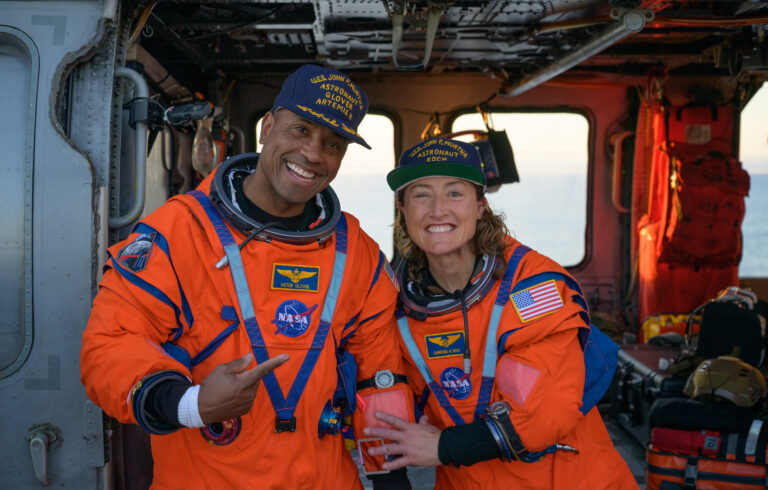 NASA astronaut Victor Glover, Artemis II pilot, left, and NASA astronaut Christina Koch, Artemis II mission specialist are seen sitting on a Navy helicopter on the flight deck of USS John P. Murtha after they and fellow crewmates CSA astronaut Jeremy Hansen, Artemis II mission specialist, and NASA astronaut Reid Wiseman, Artemis II commander, were extracted from their Orion spacecraft after splashdown. (NASA / Bill Ingalls)