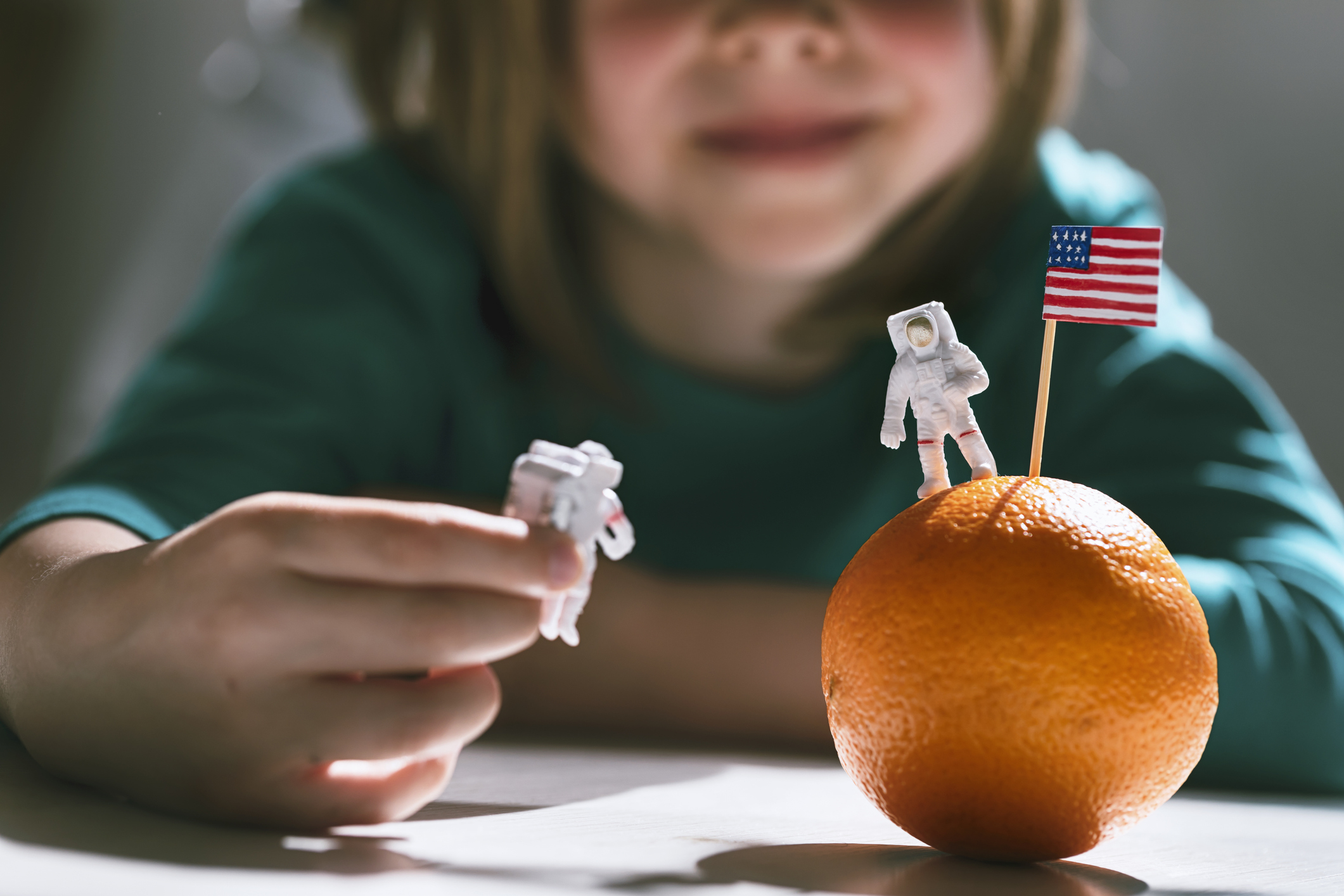 Toy astronauts land on a fruit planet (portishead1 / Getty Images)
