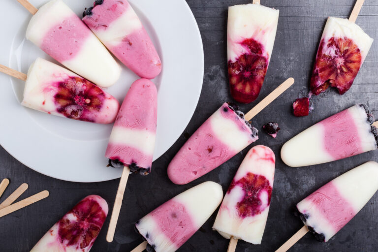 Homemade berry yogurt ice pops with frozen black currant and blood orange (istetiana / Getty Images)