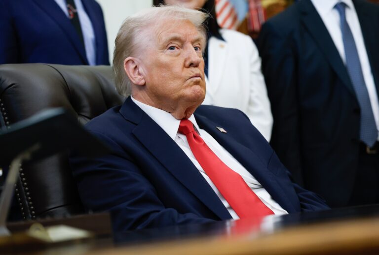 Donald Trump listens to other speakers after delivering remarks during an event in the Oval Office of the White House on October 16, 2025 in Washington, DC. Trump outlined plans to expand in vitro fertilization access by encouraging workplace benefits to include access to IVF and infertility coverage. (Photo by Kevin Dietsch/Getty Images)