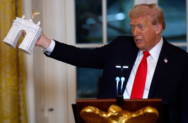 President Donald Trump holds a model of his proposed triumphal arch (Kevin Dietsch/Getty Images)