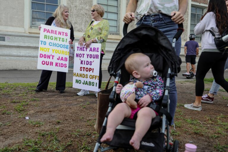 Anti-vaccine protesters stage a protest outside of the San Diego Unified School District office to protest a forced vaccination mandate for students  on September 28, 2021 in San Diego, California. The School District was holding a virtual hearing on whether to enact a mandate for students to recieve at least one dose of a COVID vaccine. ((Photo by Sandy Huffaker/Getty Images))
