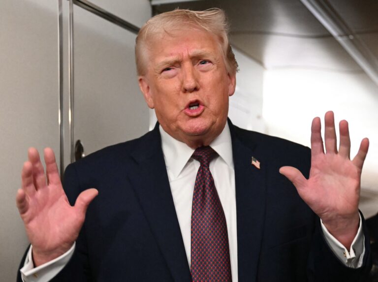 US President Donald Trump speaks to the press aboard Air Force One on January 11, 2026. (Photo by ANDREW CABALLERO-REYNOLDS/Getty Images)