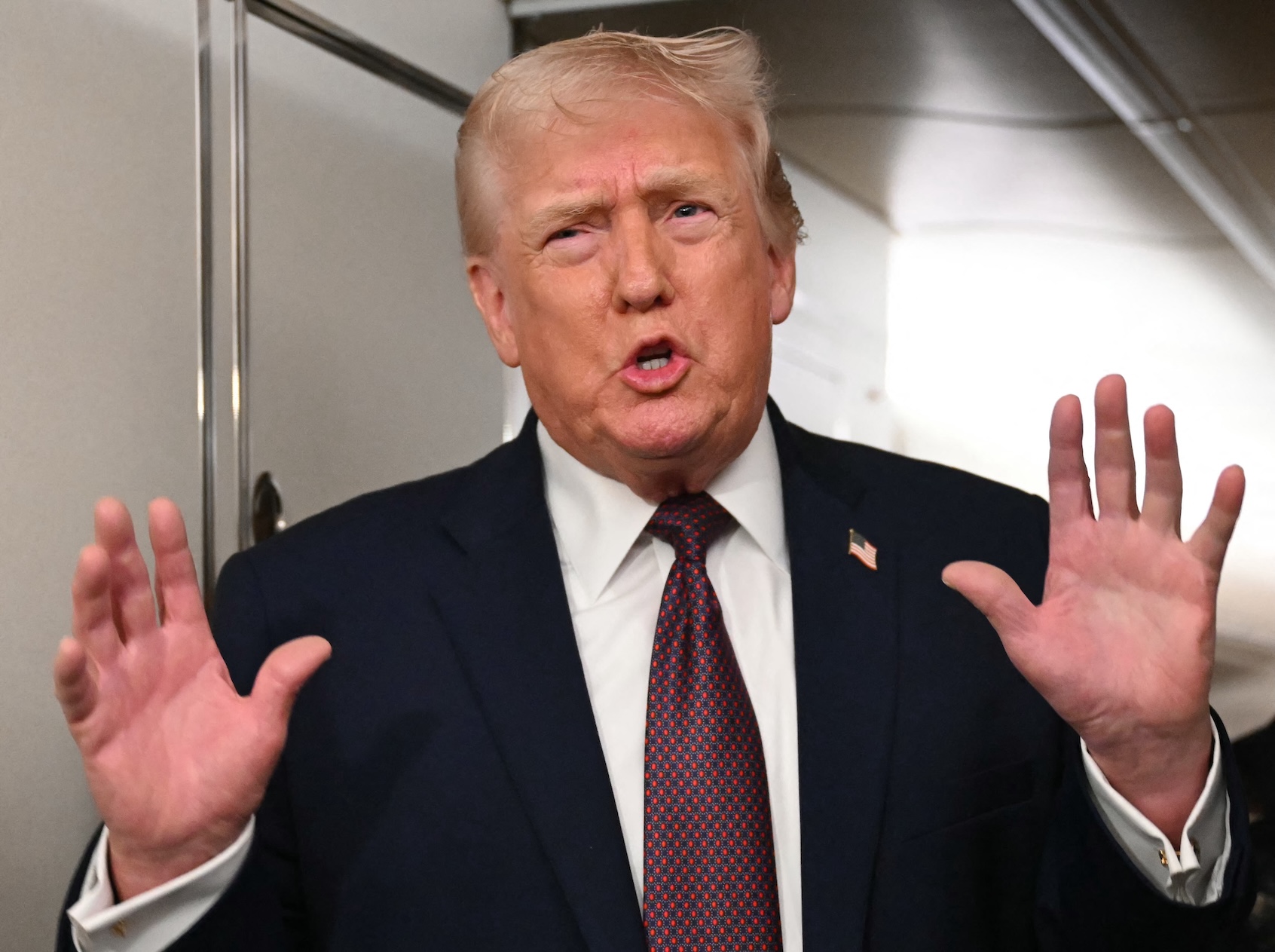 US President Donald Trump speaks to the press aboard Air Force One on January 11, 2026. (Photo by ANDREW CABALLERO-REYNOLDS/Getty Images)
