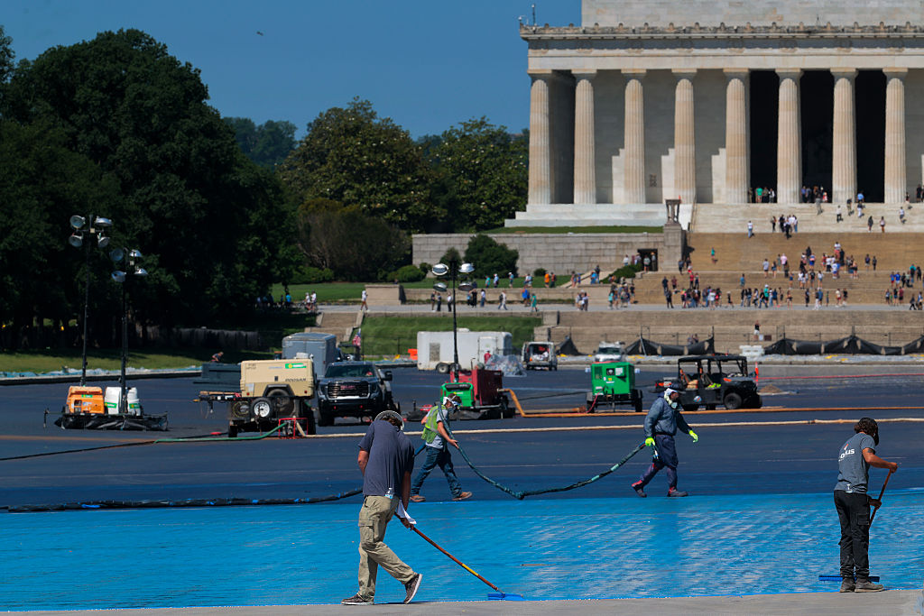 Work continues on Trump's renovations of the Reflecting Pool in D.C. as costs skyrocket and legal issues continue. He is justifying costs with false claims about Obama and Biden's expenses. (Chip Somodevilla / Getty Images)