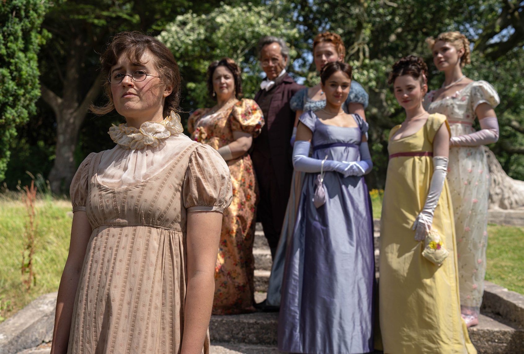 Ella Bruccoleri as Mary Bennet, Ruth Jones as Mrs Bennet, Richard E. Grant as Mr Bennet, Poppy Gilbert as Lizzie Bennet, Molly Wright as Kitty Bennet, Grace Hogg-Robinson as Lydia Bennet and Maddie Close as Jane Bennet in "The Other Bennet Sister." Credit: BBC/Bad Wolf/James Pardon (BBC/Bad Wolf/James Pardon)