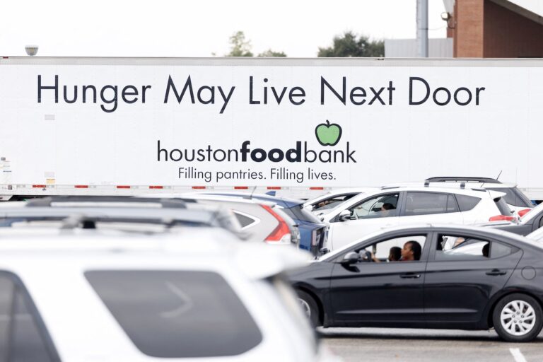 People wait in line to receive food assistance at a turkey distribution intended for federal workers and Supplemental Nutrition Assistance Program (SNAP) recipients organized by the Houston Food Bank in Houston, Texas, on November 22, 2025. Over 3,500 families were served during the food distribution, according to organizers. (Photo by Mark Felix / AFP)