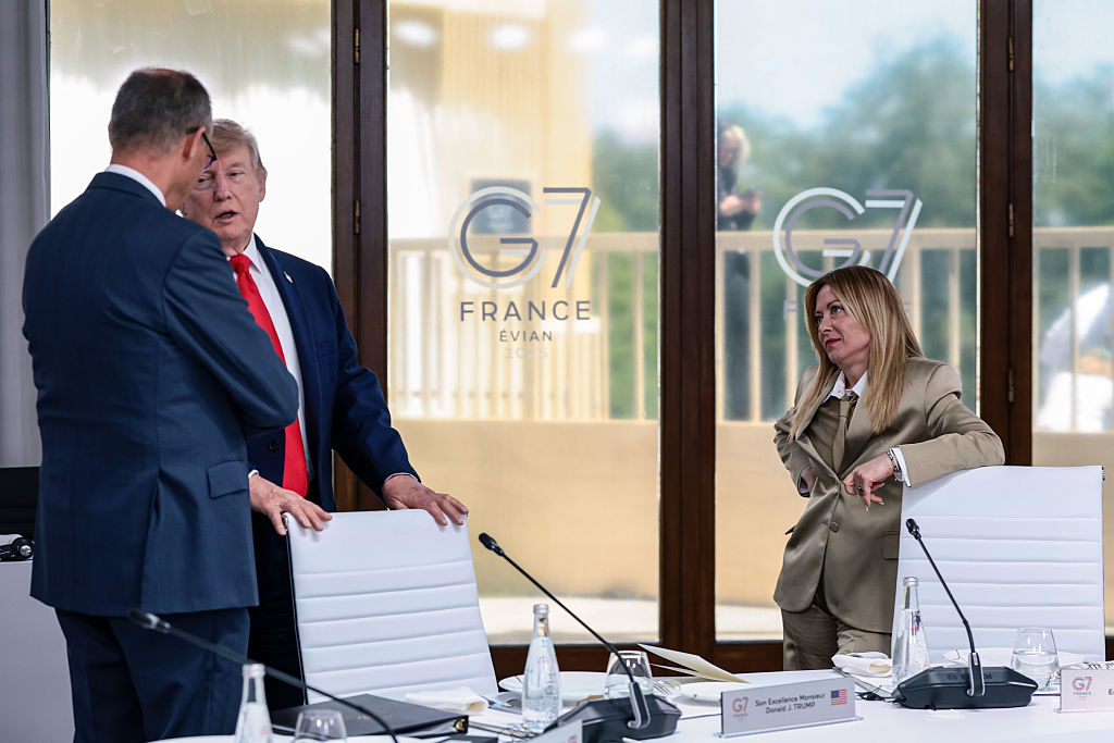 President Donald Trump speaks with German Chancellor Friedrich Merz as Italian Prime Minister Giorgia Meloni waits at a working lunch with leaders of G7 and the Middle East this month in France. (Evelyn Hockstein / Getty Images)