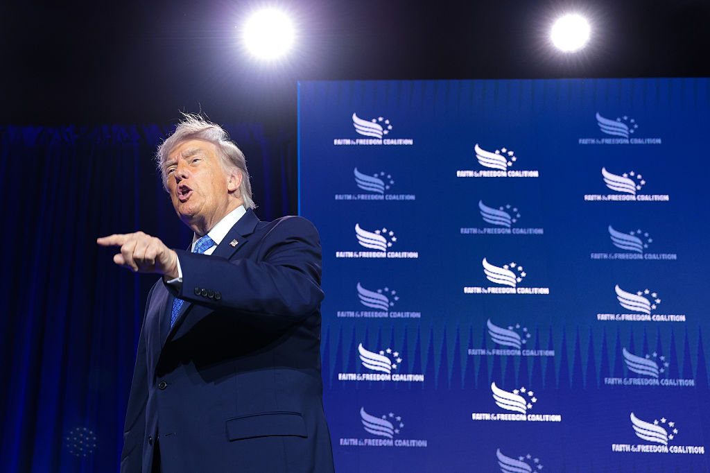 President Trump, at this year's Faith & Freedom conference, spoke to a crowd of evangelicals warning them about the "greatest threat" to America — the "godless communist" democrats. (Anna Moneymaker / Getty Images)