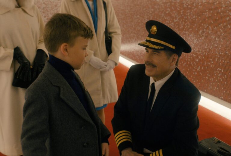 Clark Shotwell and John Travolta in "Propeller One-Way Night Coach" (Apple TV)