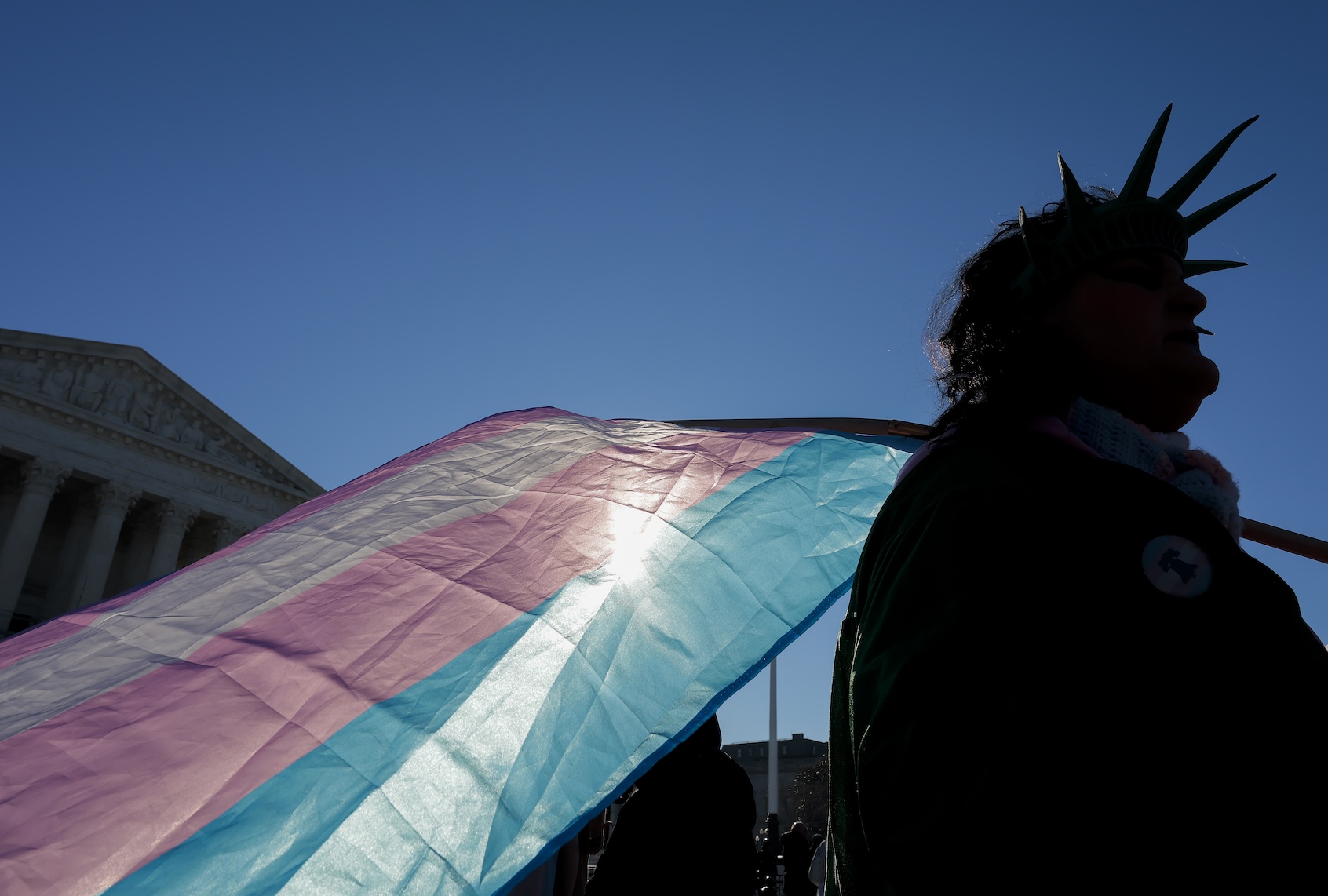 A protester supporting transgender athletes competing in women's sports holds a transgender pride flag outside the Supreme Court on January 13, 2026 in Washington, DC. (Photo by Heather Diehl/Getty Images)