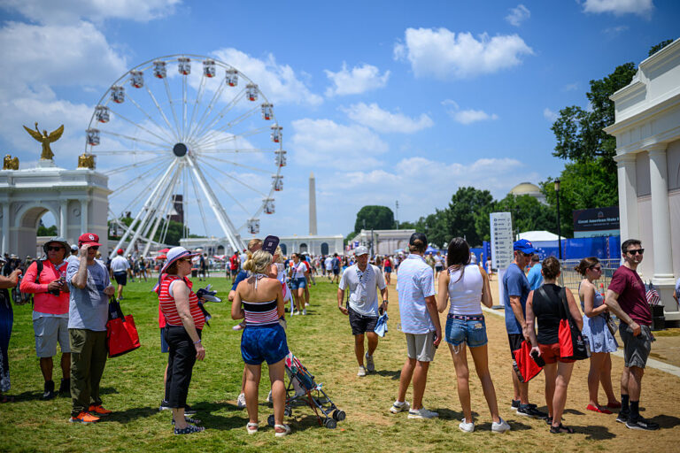 People wait in line for exhibits at the Great American State Fair, a part of Freedom250's events. Many guests were hampered by extreme heat and few places of cool rest. (Alexi J. Rosenfeld / Getty Images)