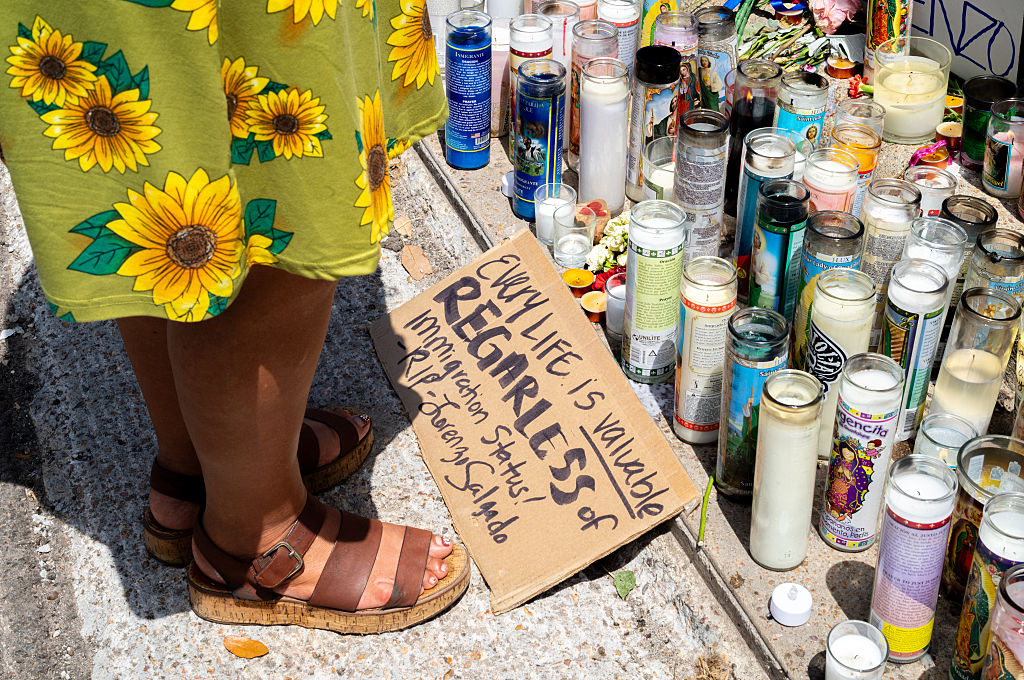 A woman pays tribute to the memory of Lorenzo Salgado Araujo, who was shot during an encouter with ICE agents in his hometown of Houston. Witnesses are challenging the official government report of justified homicide. (Brandon Bell / Getty Images)