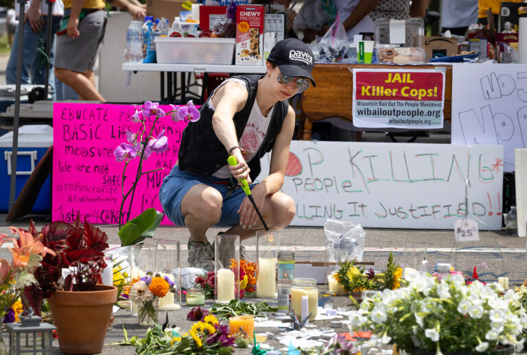 People visit a makeshift memorial at the intersection where Corey Ruiz was shot and killed by Madison Police on July 23, 2026 in Madison, Wisconsin. (Scott Olson/Getty Images))