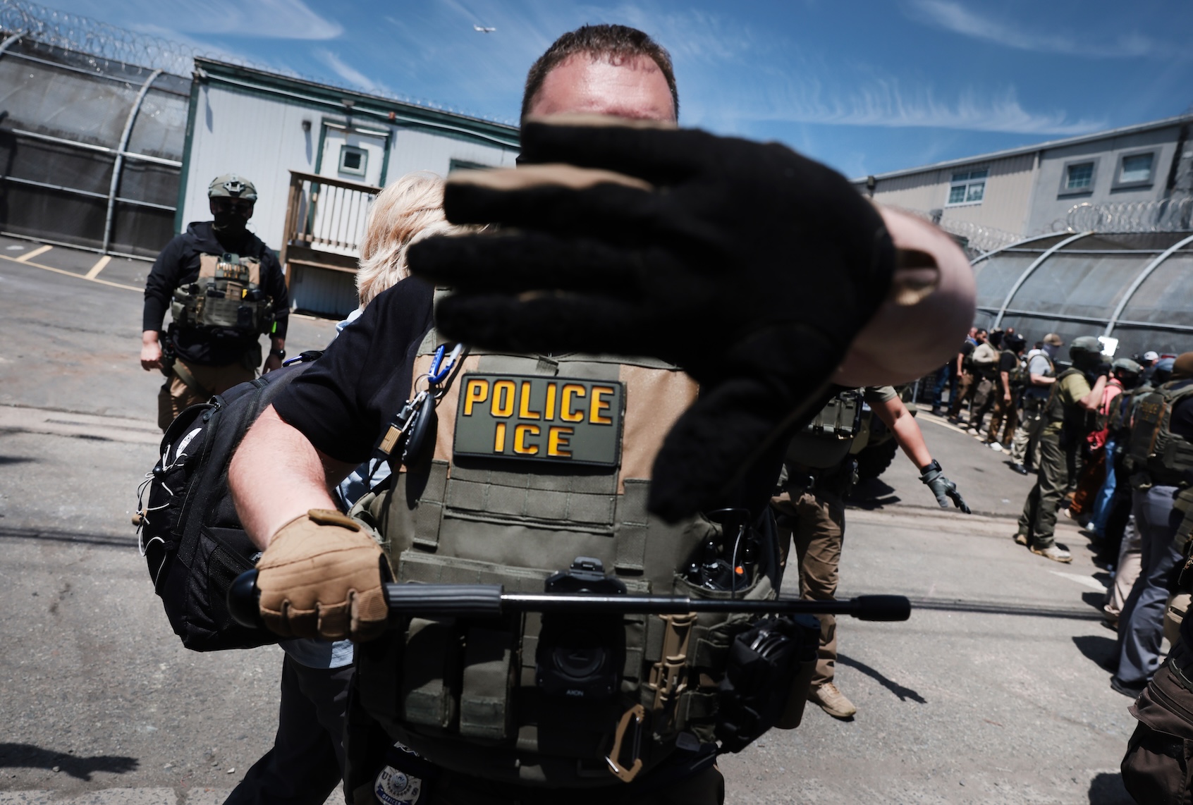 ICE agents stand guard in front of protesters outside Delaney Hall which is being used as an Immigration and Customs Enforcement detention centeron May 26, 2026 in Newark, New Jersey. (Photo by Spencer Platt/Getty Images)
