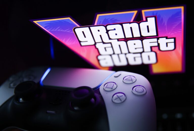 GTA VI logo from the trailer displayed on a laptop screen and PlayStation DualSense controller. (Photo by Jakub Porzycki/NurPhoto via Getty Images)