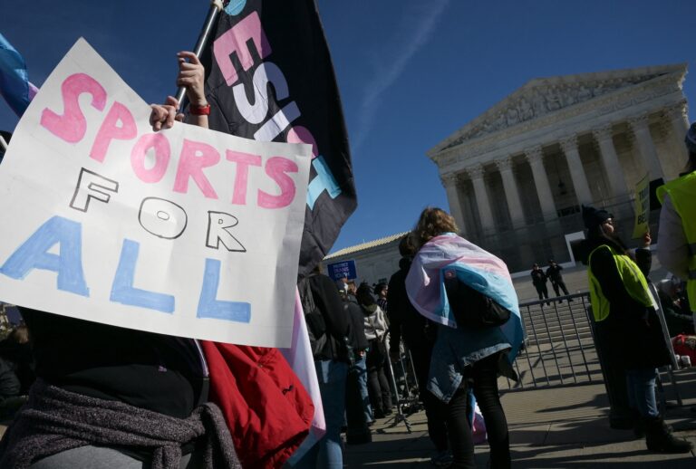 LGBTQ+ rights advocates rally outside the US Supreme Court as justices hear arguments in challenges to state bans on transgender athletes in women's sports on January 13, 2026, in Washington, DC. (Photo by Oliver Contreras / AFP via Getty Images)