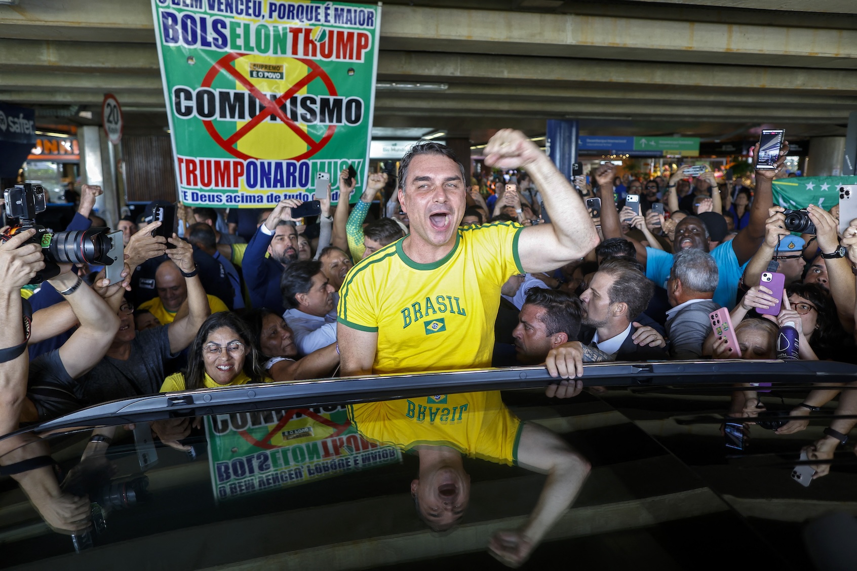 Brazilian presidential candidate Flávio Bolsonaro, son of imprisoned former president Jair Bolsonaro, greets supporters at the Brasília airport, May 28, 2026. (Sergio Lima/AFP via Getty Images)