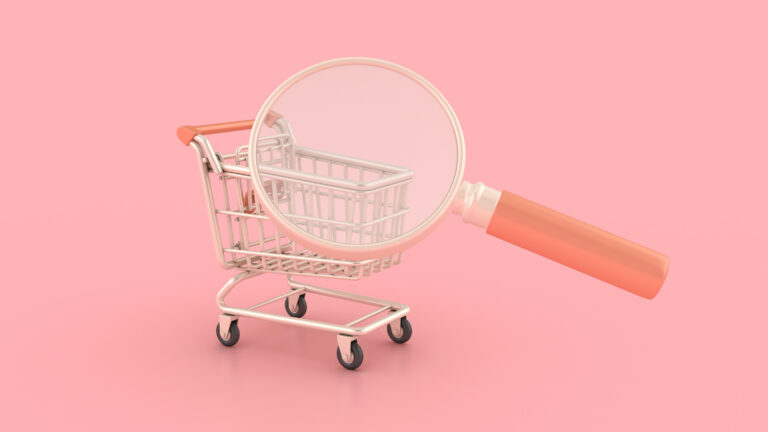 Magnifying glass over a shopping cart (porocorex / Getty Images)