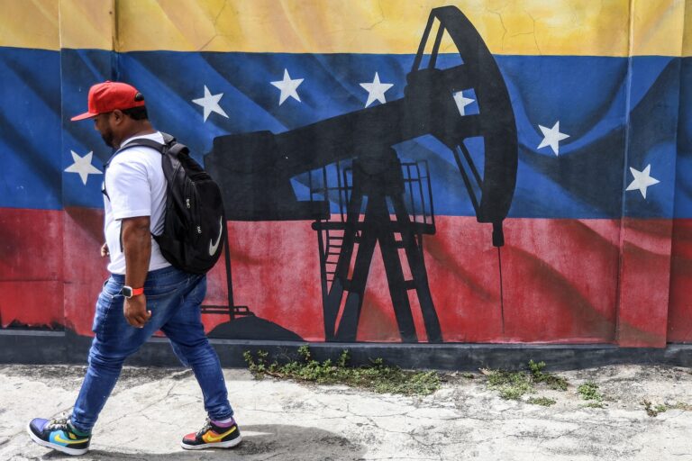 Mural in Caracas depicting an oil pumpjack against a Venezuelan flag. (Pedro Mattey/AFP via Getty Images)