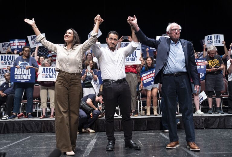 Rep. Alexandria Ocasio-Cortez (D-NY), Michigan Democratic candidate for Senate Abdul El-Sayed and U.S. Sen. Bernie Sanders (I-VT) greet the crowd after El-Sayed spoke at The People V. The Powerful rally at the Detroit Opera House on July 18, 2026 in Detroit, Michigan. (Photo by Sarah Rice/Getty Images)