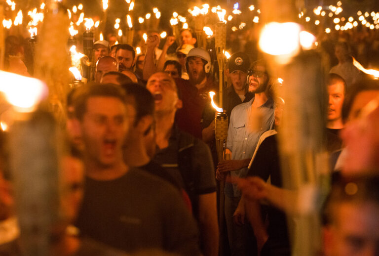 White supremacists carry torches during a march at the University of Virginia in Charlottesville, Virginia, Aug. 11, 2017, the night before the "Unite the Right" rally. (Zach D Roberts / NurPhoto via Getty Images)