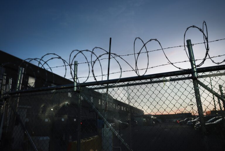 Barbed wire lines a fence outside of the Delaney Hall Detention Facility , where ICE is housing detained immigrants, on August 4, 2026, in Newark, New Jersey. The demand for a shutdown continues  after El Salvadoran immigrant Edwin Lopez-Cornejo died  on August 1st while in custody at the facility.  He was the 22nd person to die in ICE custody this year. (Photo by Spencer Platt/Getty Images)