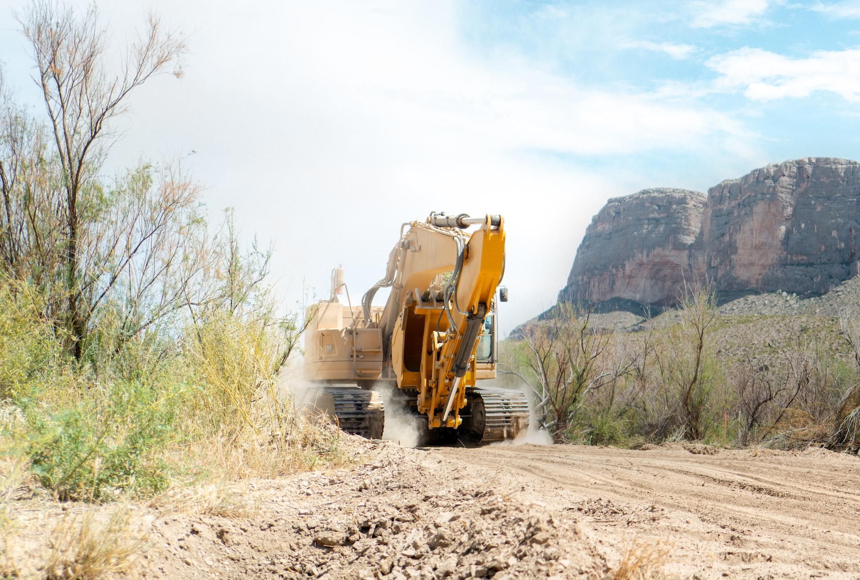 An excavator plows through land during construction for a section of border wall near Santa Elena Canyon on August 14, 2026 in Big Bend National Park, Texas. Contractors have begun construction of the Trump administration’s 30-foot southern border wall through Big Bend National Park. (Photo by Brandon Bell/Getty Images)