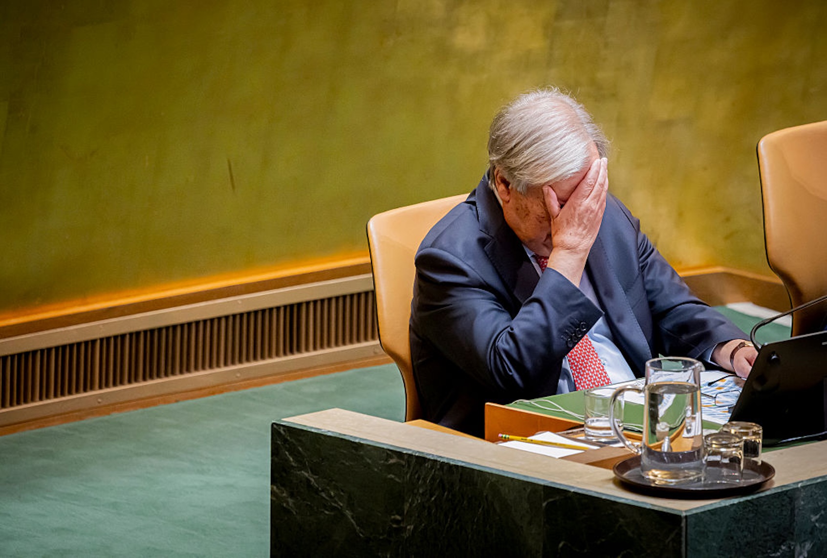 United Nations Secretary General Antonio Guterres covers his face with his right hand as President Donald Trump speaks before the U.N. General Assembly