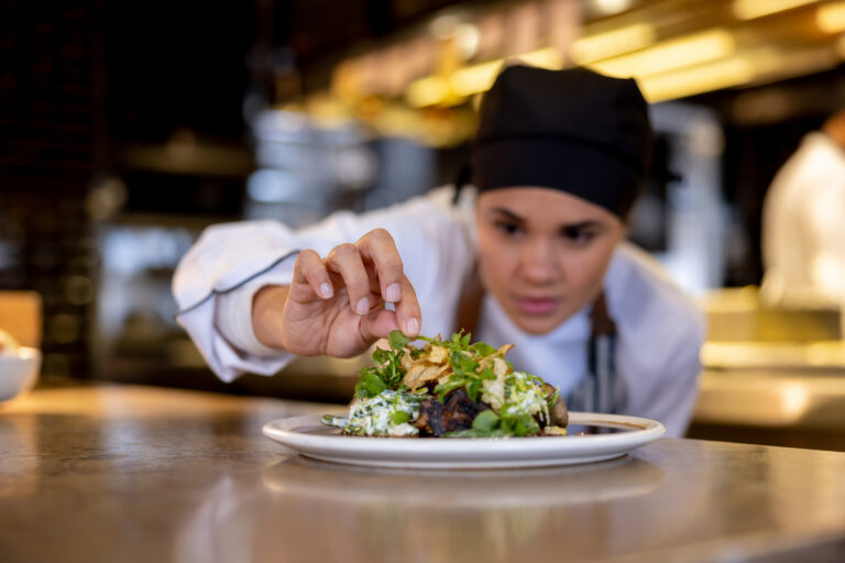 Chef decorating a plate (Hispanolistic / Getty Images)