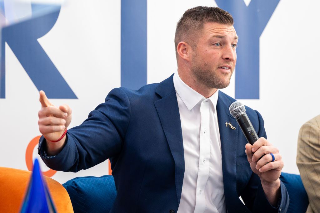 Christian athlete and celebrity Tim Tebow helped promote a financial organization that is now under investigation for its predatory practices under the guise of a worship event. (Derek White / Getty Images)