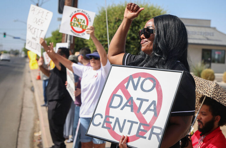 Rural California demonstrators wave signs during a nationwide protest against AI data center expansion. (SANDY HUFFAKER / Getty Images)