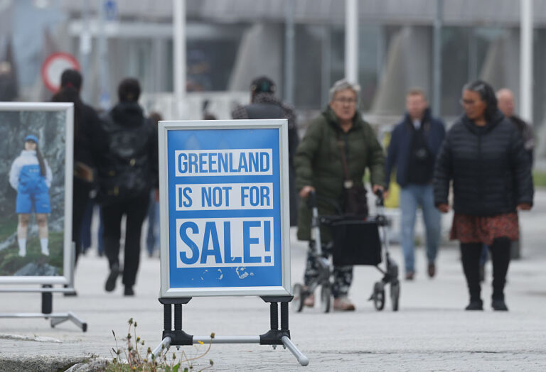 In Greenland, this summer, people walk past a shop's placard that reads "Greenland is not for sale!" President Donald Trump has repeatedly voiced his desire for the US to acquire Greenland, but the nations have now settled on a new security plan to be finalized at the UN General Assembly. (Sean Gallup / Getty Images)
