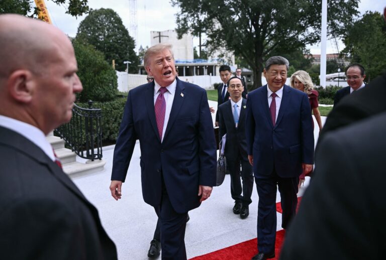 Donald Trump speaks briefly with the press as he walks with China's President Xi Jinping on September 24, 2026. (Photo by Brendan SMIALOWSKI / AFP via Getty Images)