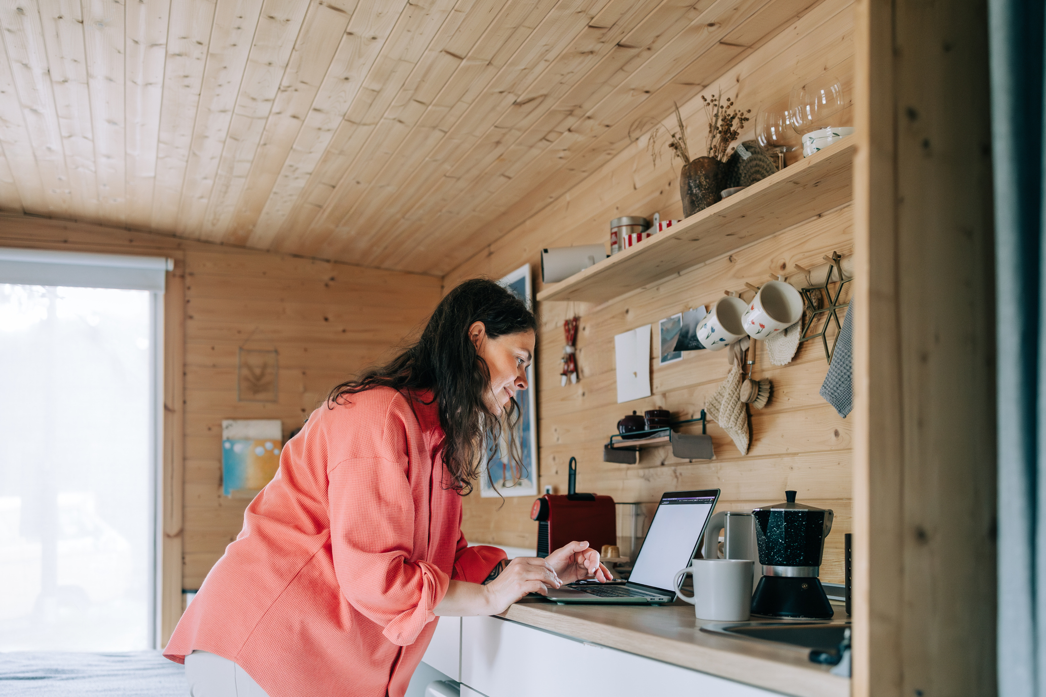 Woman working remotely a rental property (Olga Pankova / Getty Images)