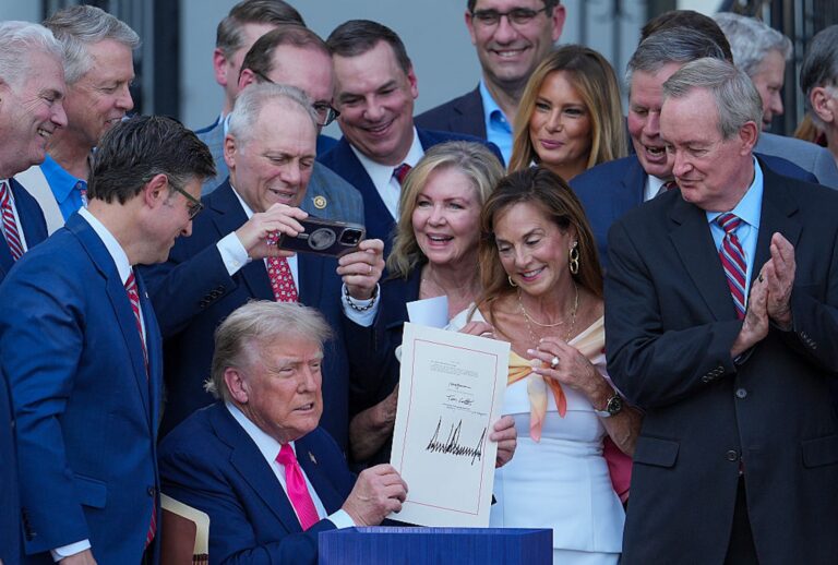 President Donald Trump signs the One Big Beautiful Bill Act into law at the White House on July 4, 2025. (Eric Lee/Getty Images)