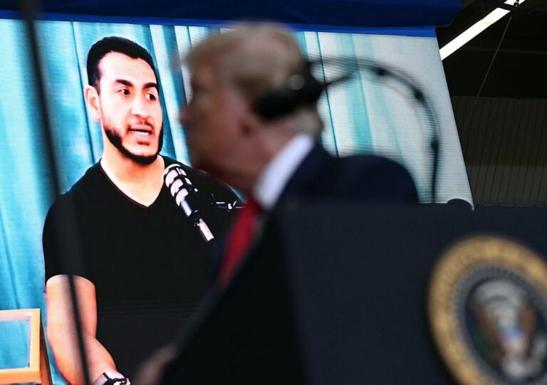 President Donald Trump stands in front of a screen showing Democratic Senate candidate Dr. Abdul El-Sayed as he speaks during a campaign rally in Port Huron, Michigan, on Oct. 25, 2026. (Brendan SMIALOWSKI / AFP)
