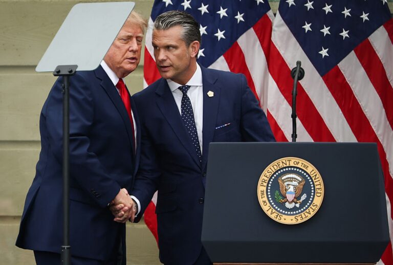President Donald Trump shakes hands with Defense Secretary Pete Hegseth during a ceremony at the Pentagon commemorating the 25th anniversary of the Sept. 11th terrorist attacks. (Finn Gomez/Getty Images)